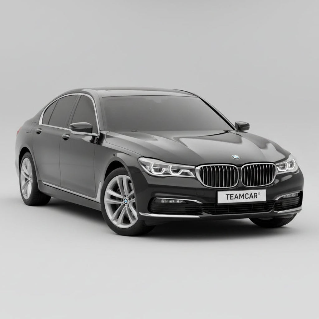 Black BMW car on a gravel surface with visible license plate and branding in the background.