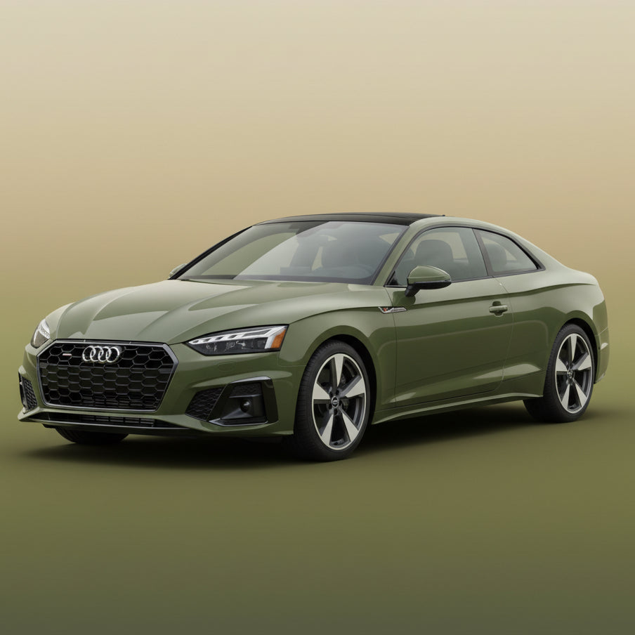 Green Audi car parked on a street with a modern building in the background