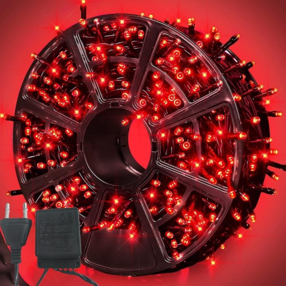 Spool of red string lights with a plug on a red background