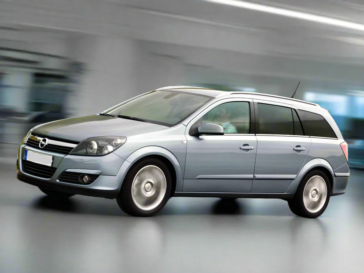 Silver Opel Astra station wagon in motion with a blurred background