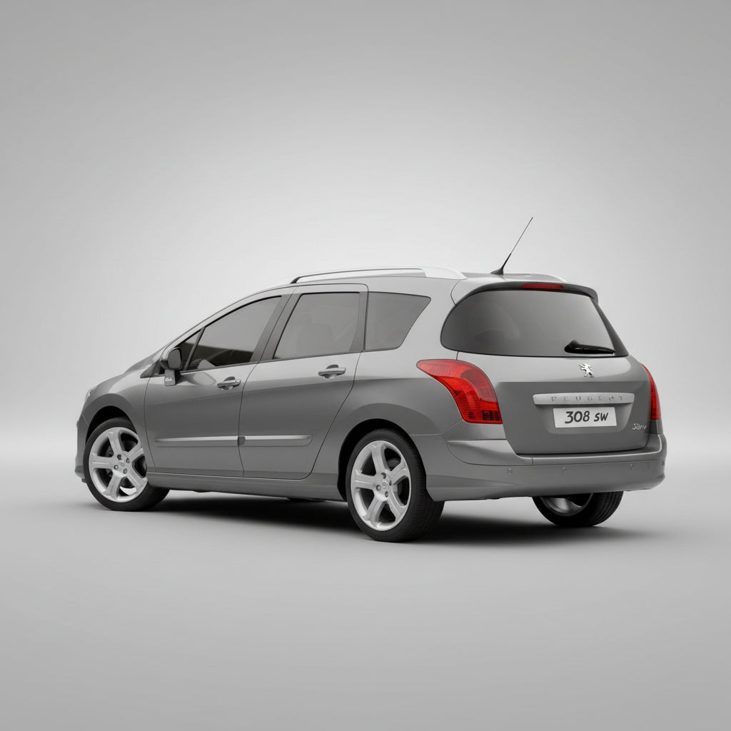 Gray Peugeot 308 SW car on a grassy area with trees in the background