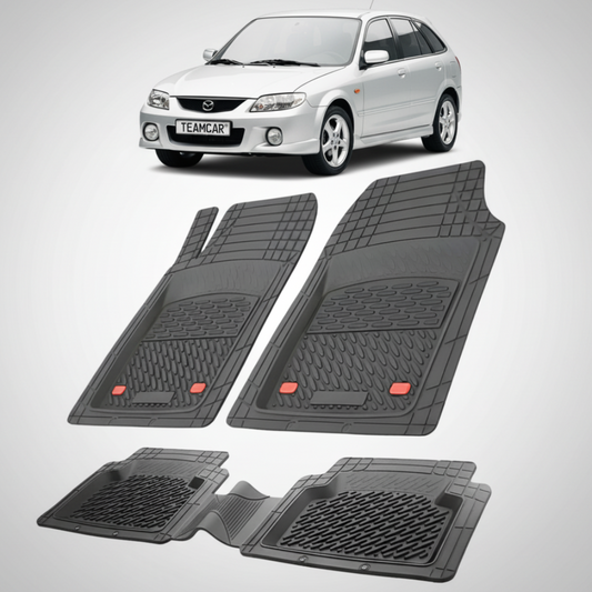 set de covorase din cauciuc negre cu o mazda 323 bj facelift hatchback 5 usi argintie in fundal