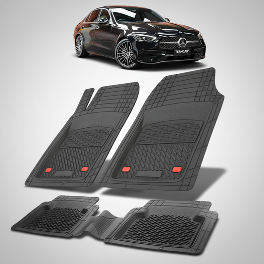 Set of black car floor mats with a Mercedes-Benz car in the background.