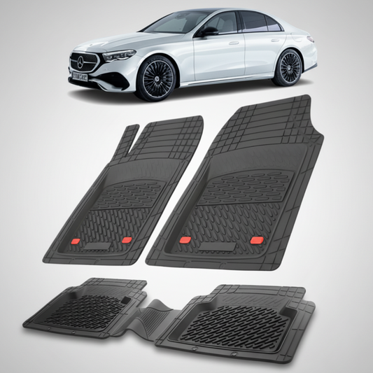 Set of black car floor mats with a white Mercedes-Benz car in the background.