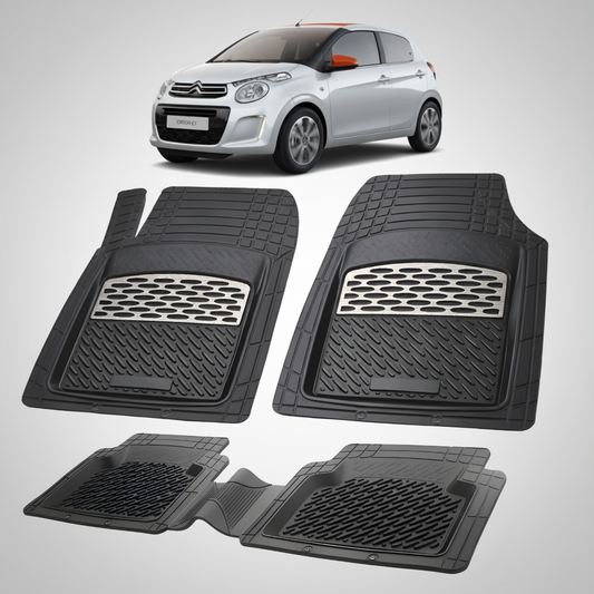 Set of black car floor mats with a car in the background